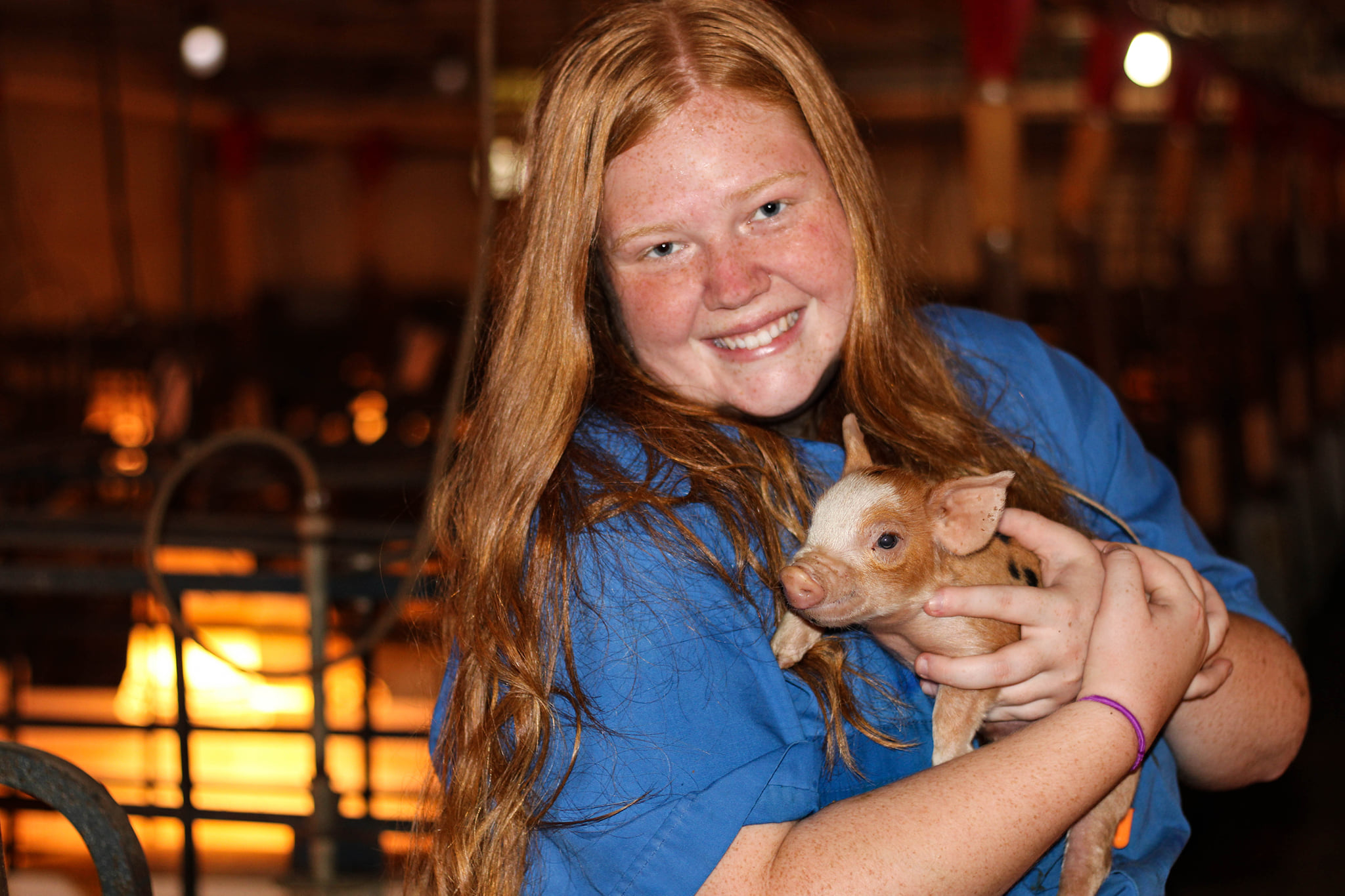 Grace holds a baby pig