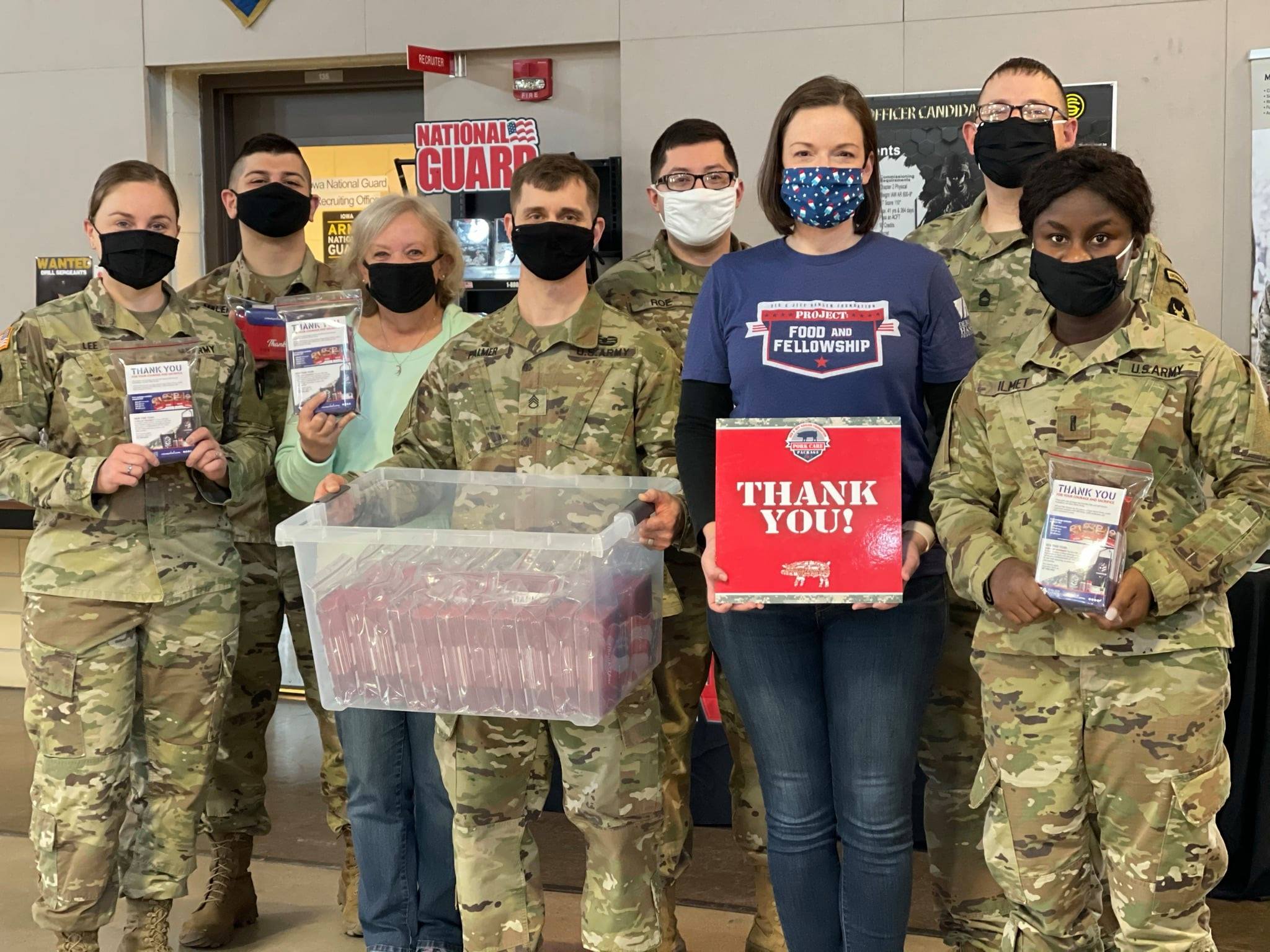 A group of military members receive pork donations.