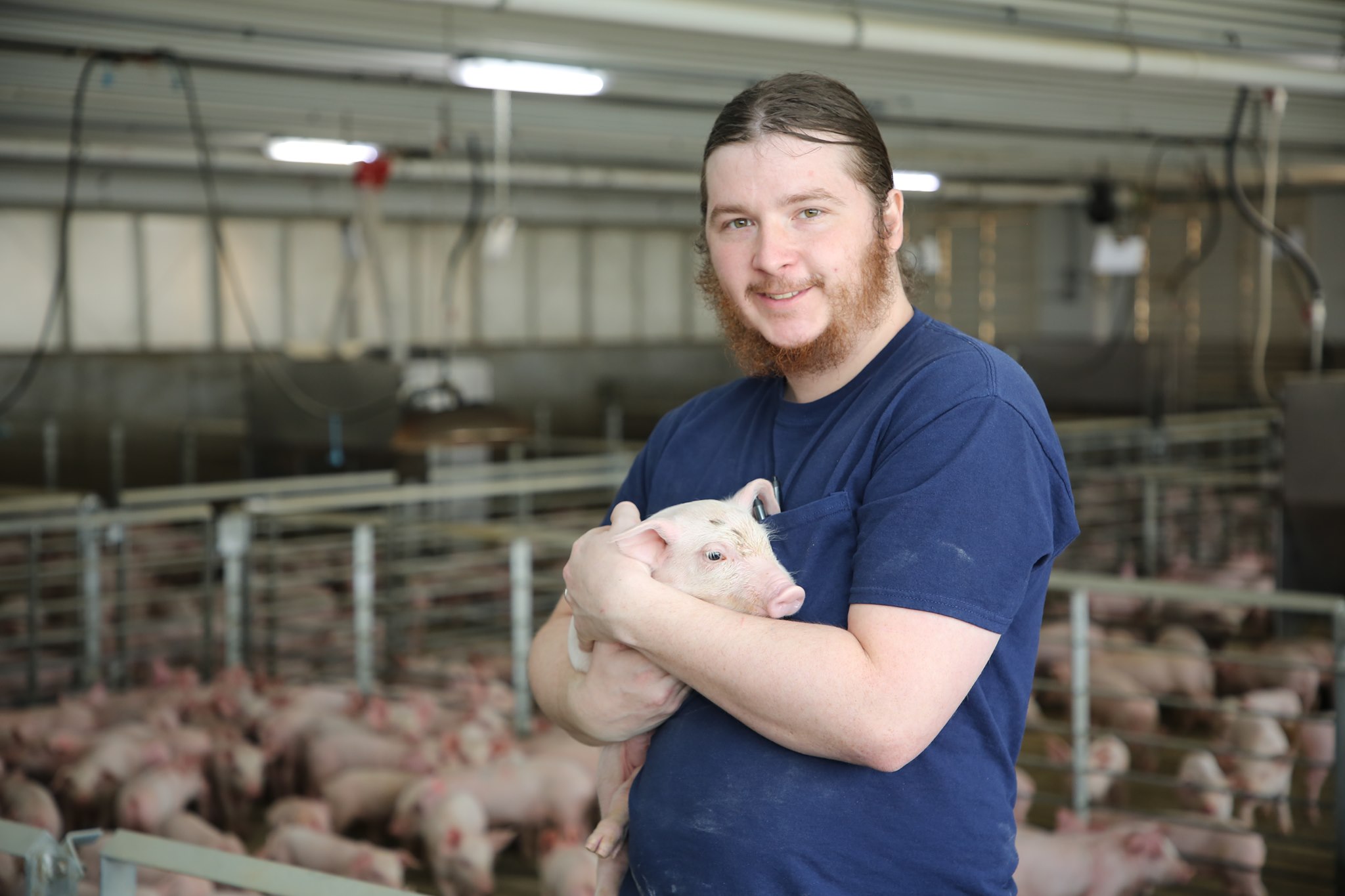 Cody holds a young pig.