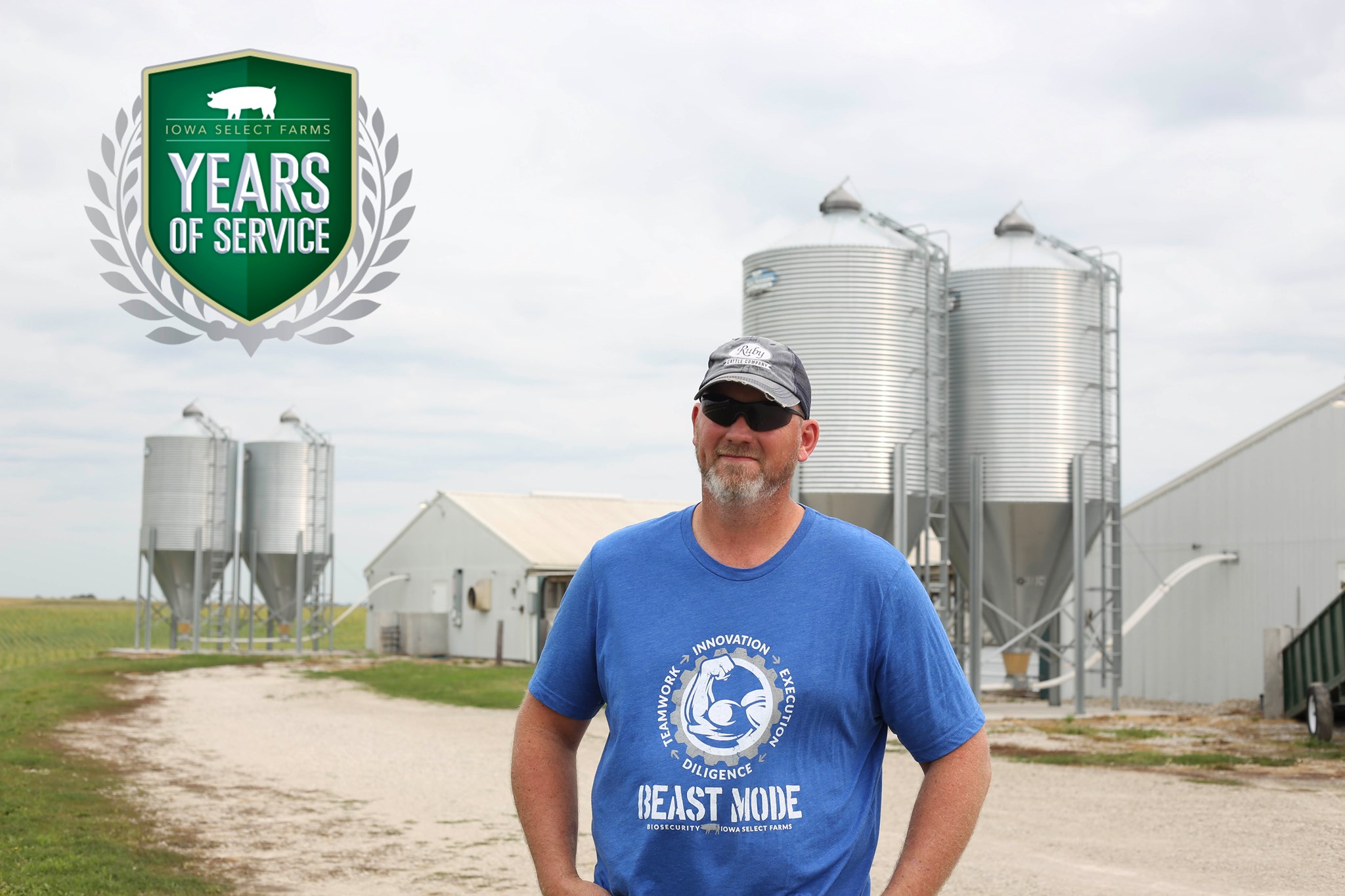 Clint poses in front of some outdoor pig feeders.