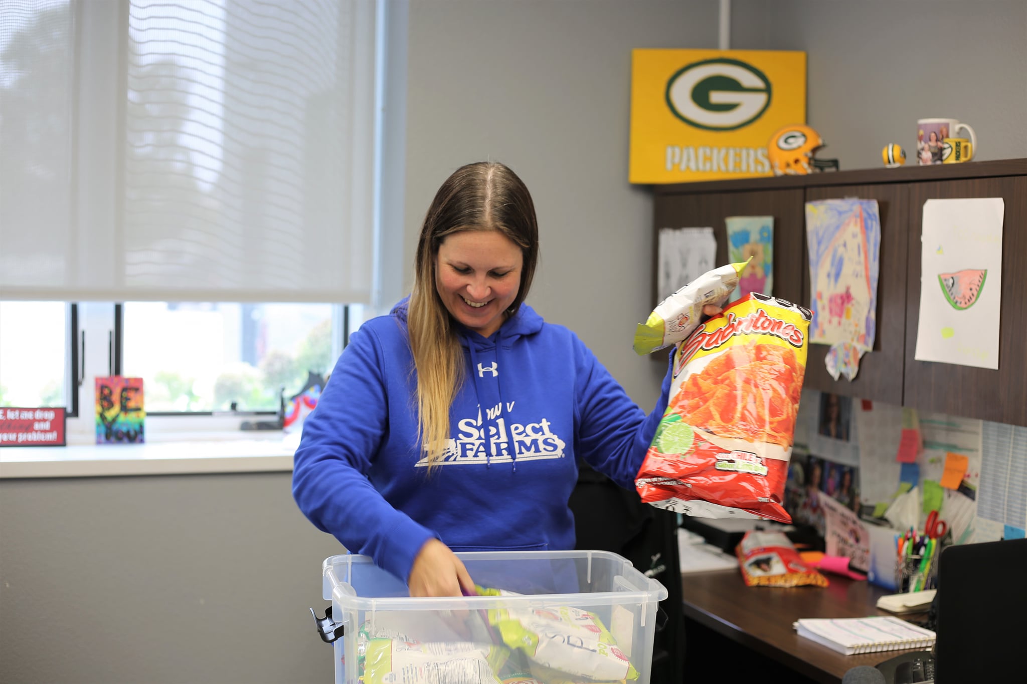 A woman opens a box full of snacks