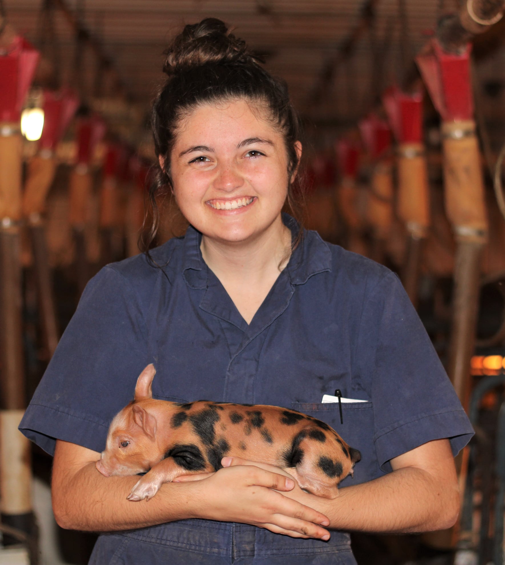 TJ holds a baby pig.