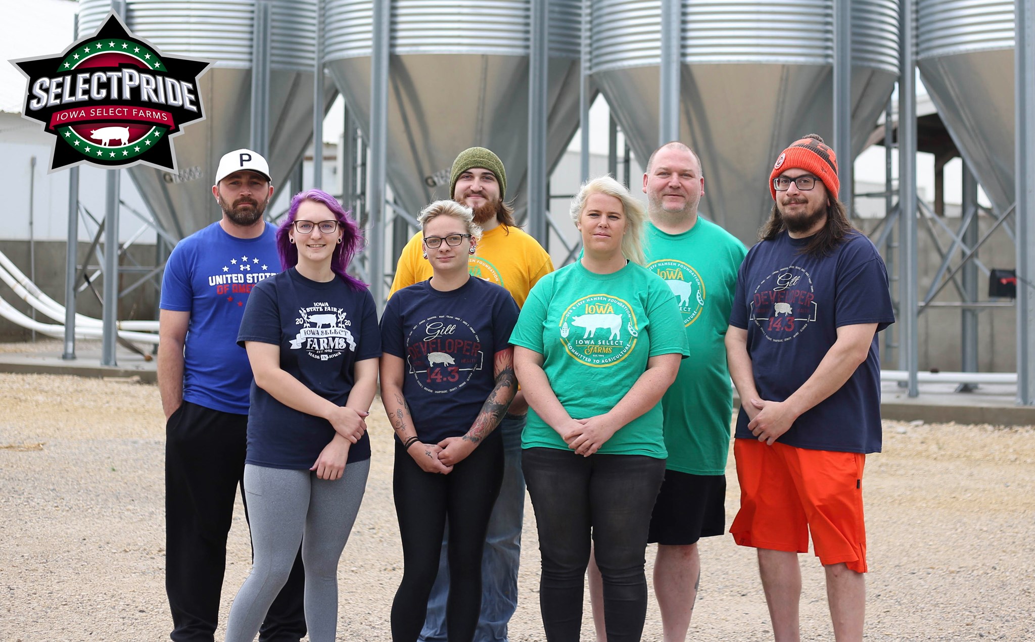 The farm team stands outside the farm.