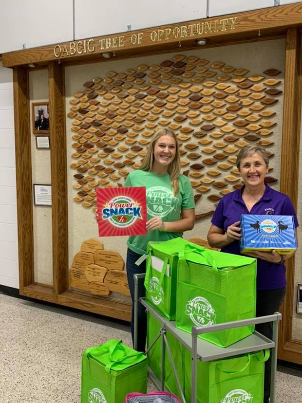 School personnel hold Power Snack materials