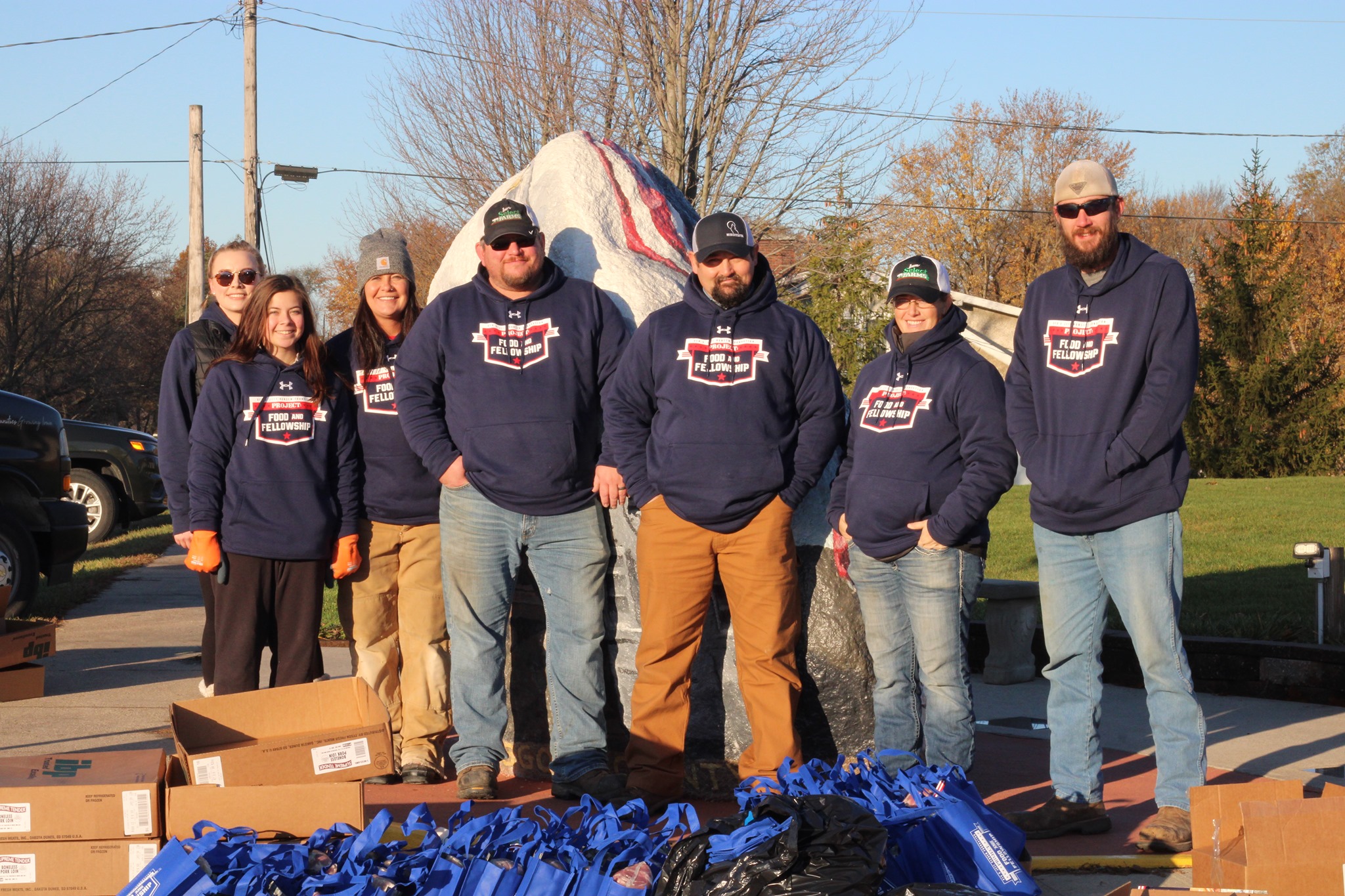 a group of volunteers smiles for the camera