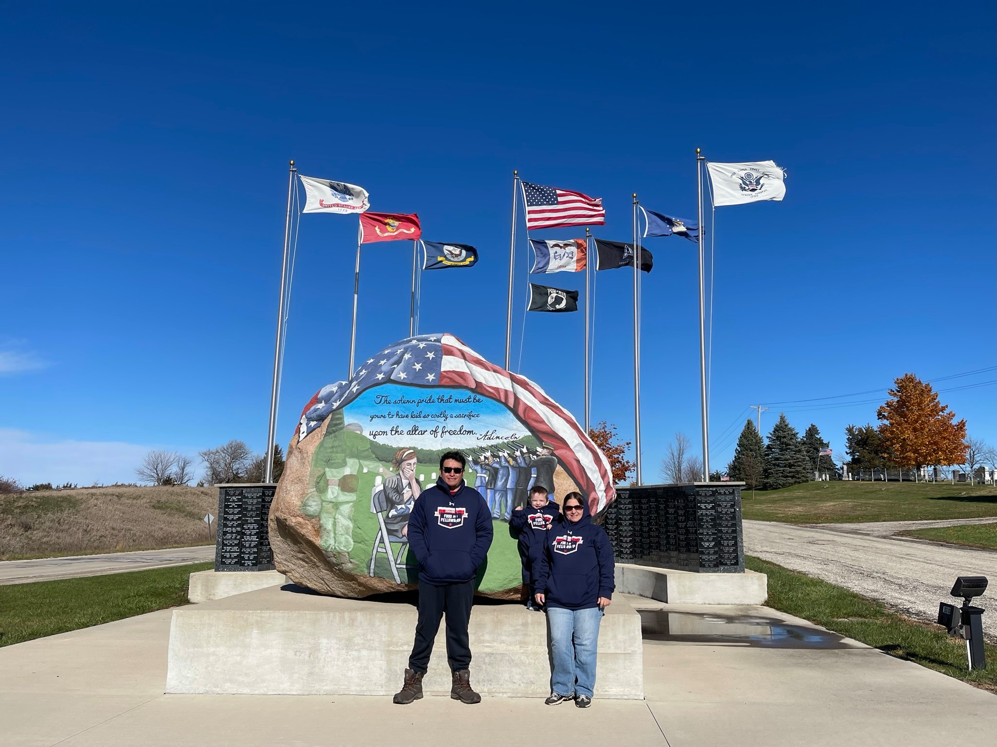 volunteers stand in front of the freedom rock