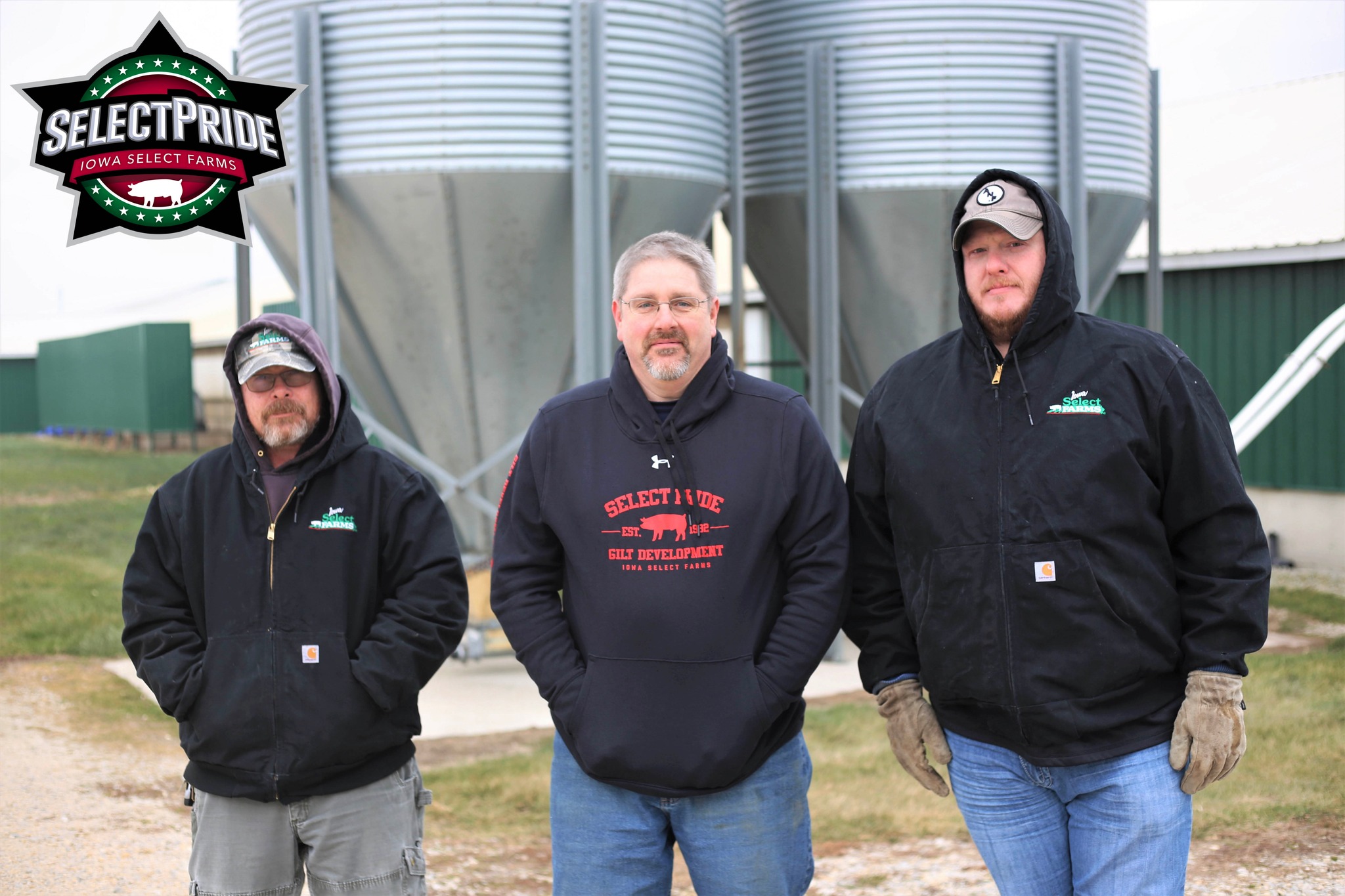 the three men pose for a group photo