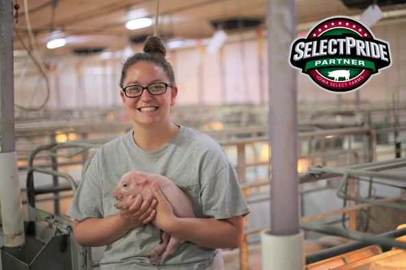 T'Lee holding small piglet