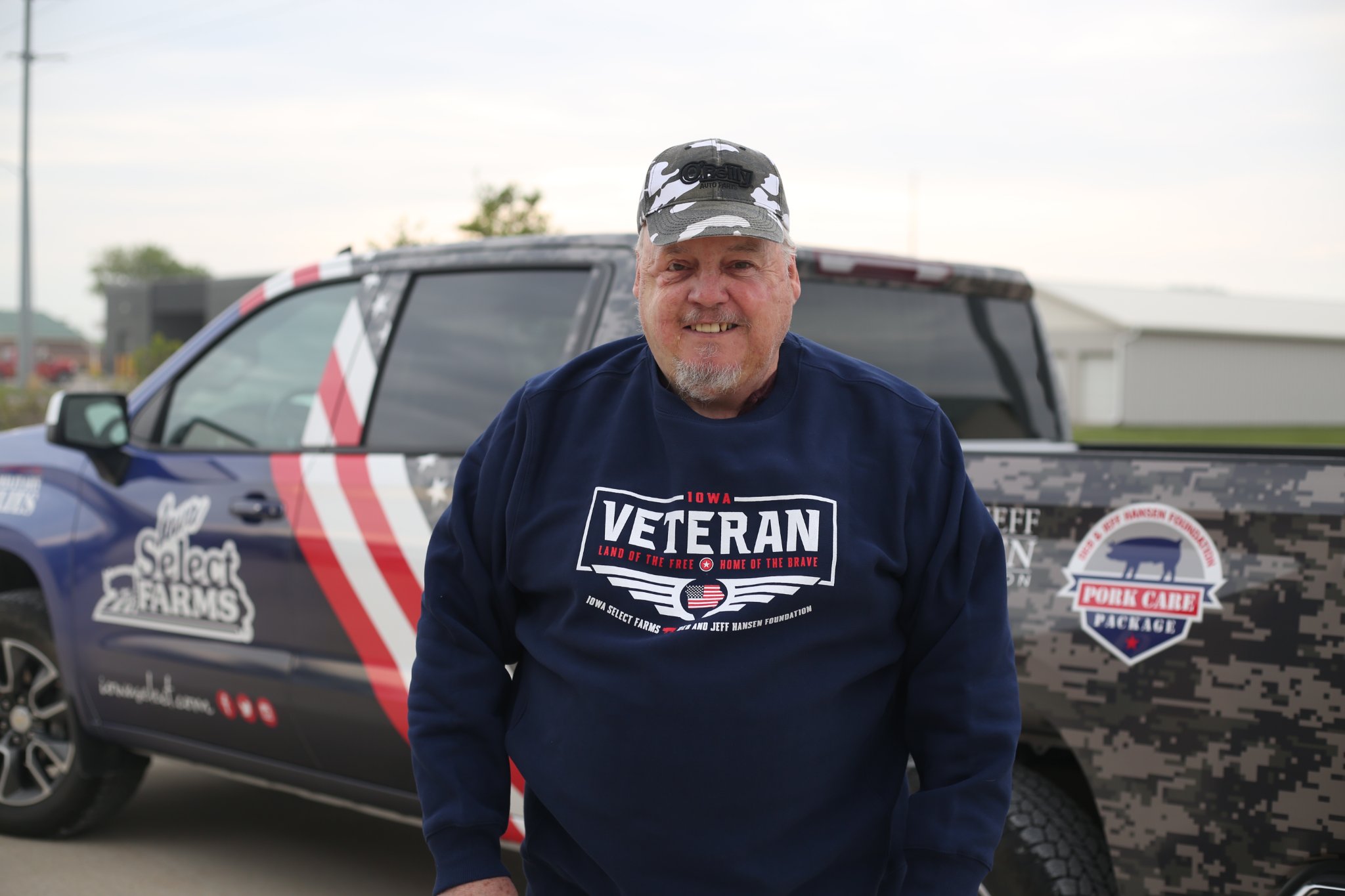 Terry smiling by the military truck