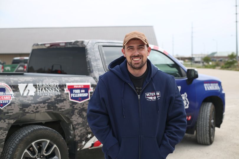 Nick Seaburg standing next to military truck