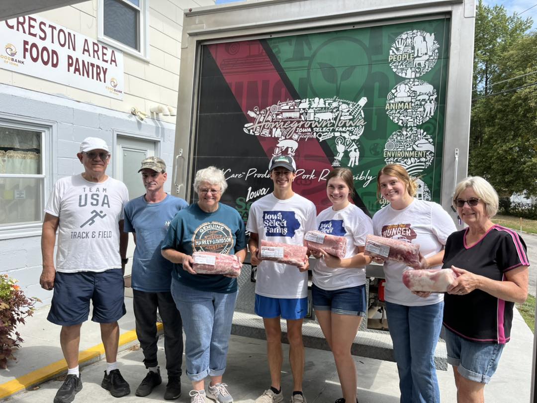 Creston Food Pantry worker and ISF emp. standing by box truck