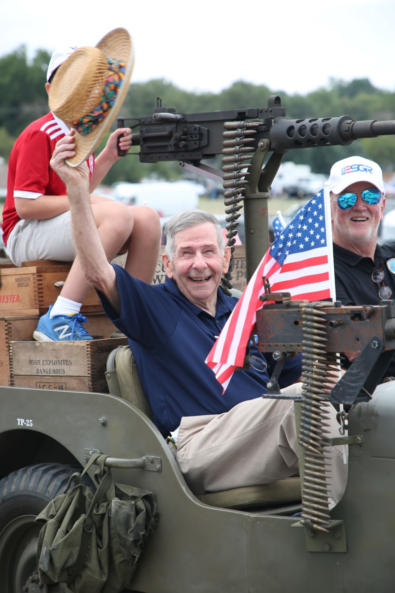 Veteran waves his hat.