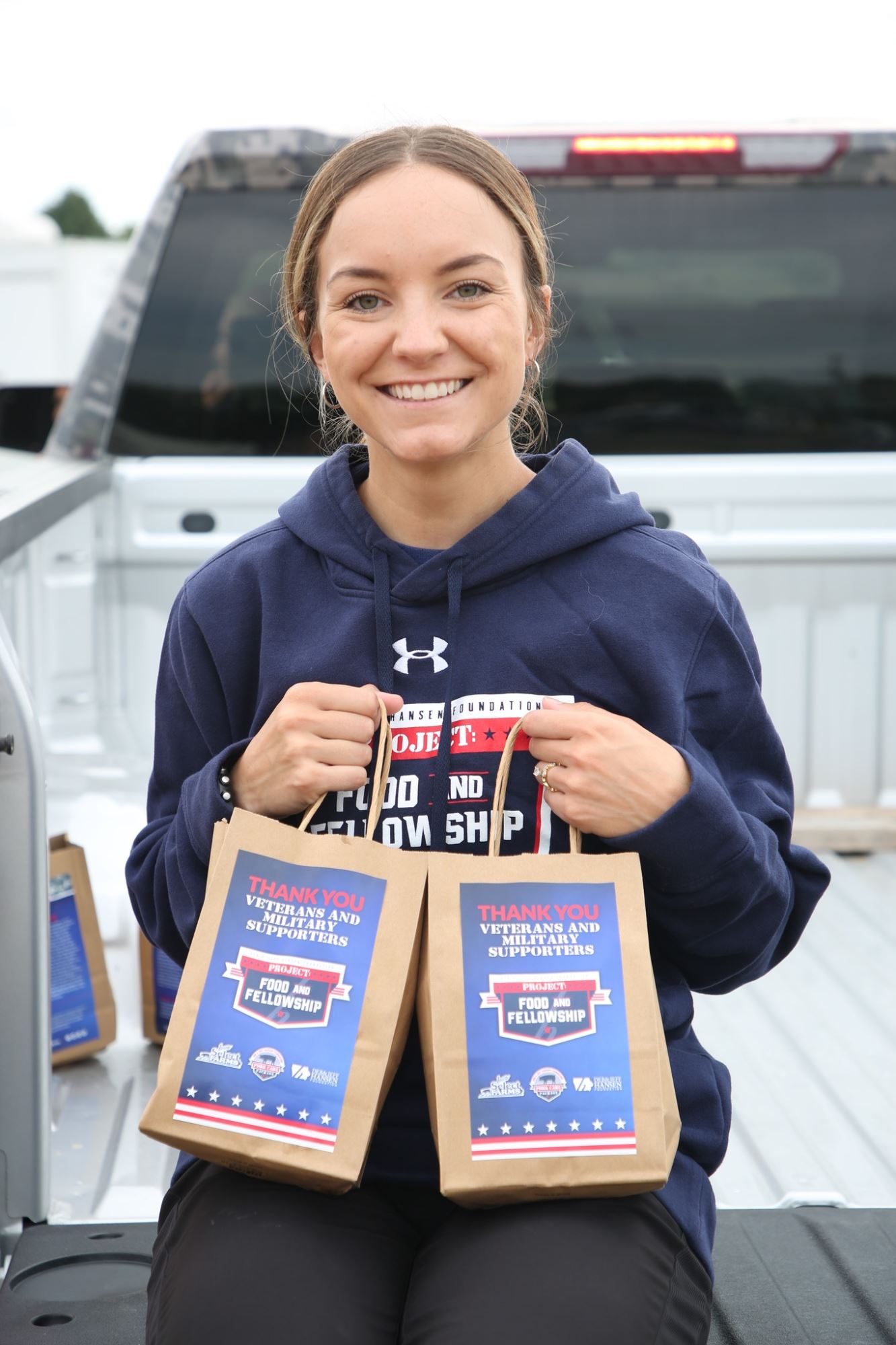 Madison holding breakfast bags.