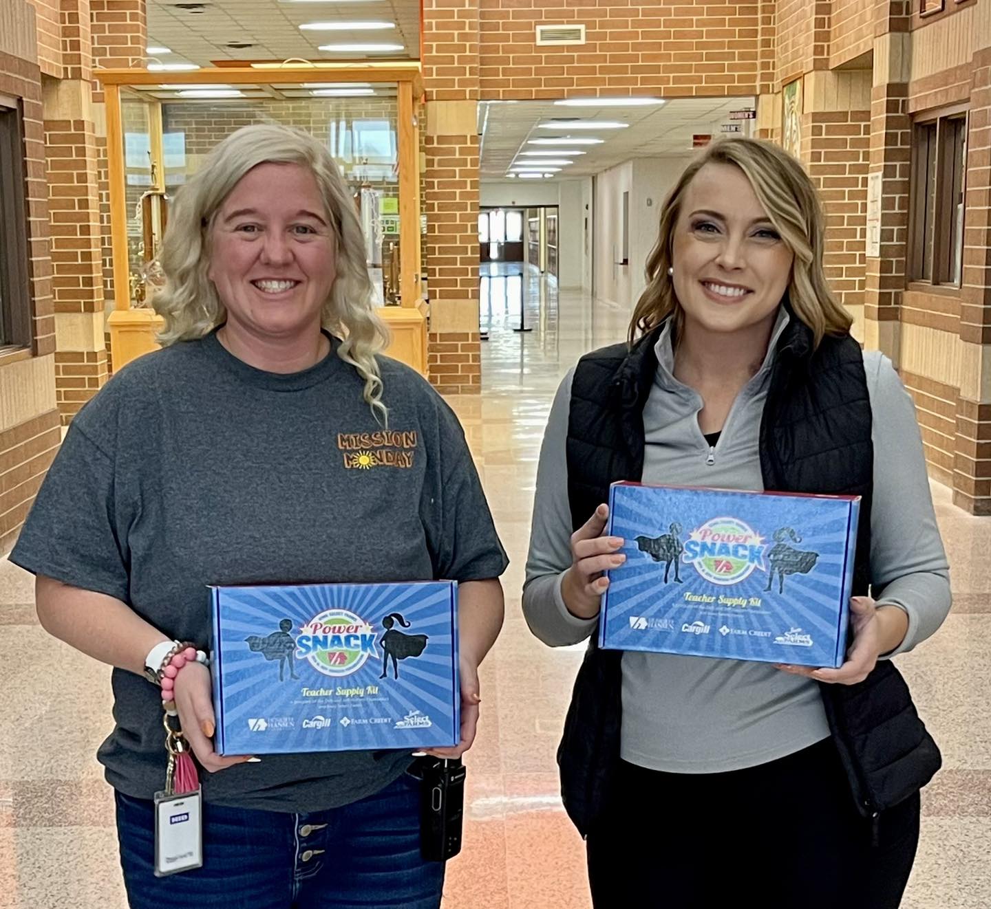 Ali with staff member holding Power Snack coupons