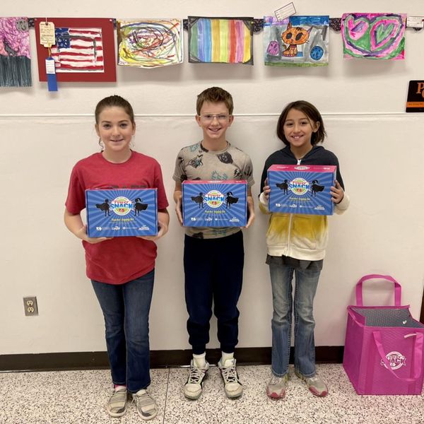 Children holding Power Snack coupon boxes