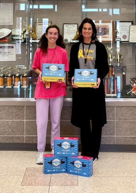 Staff at Carroll Middle School holding coupons boxes
