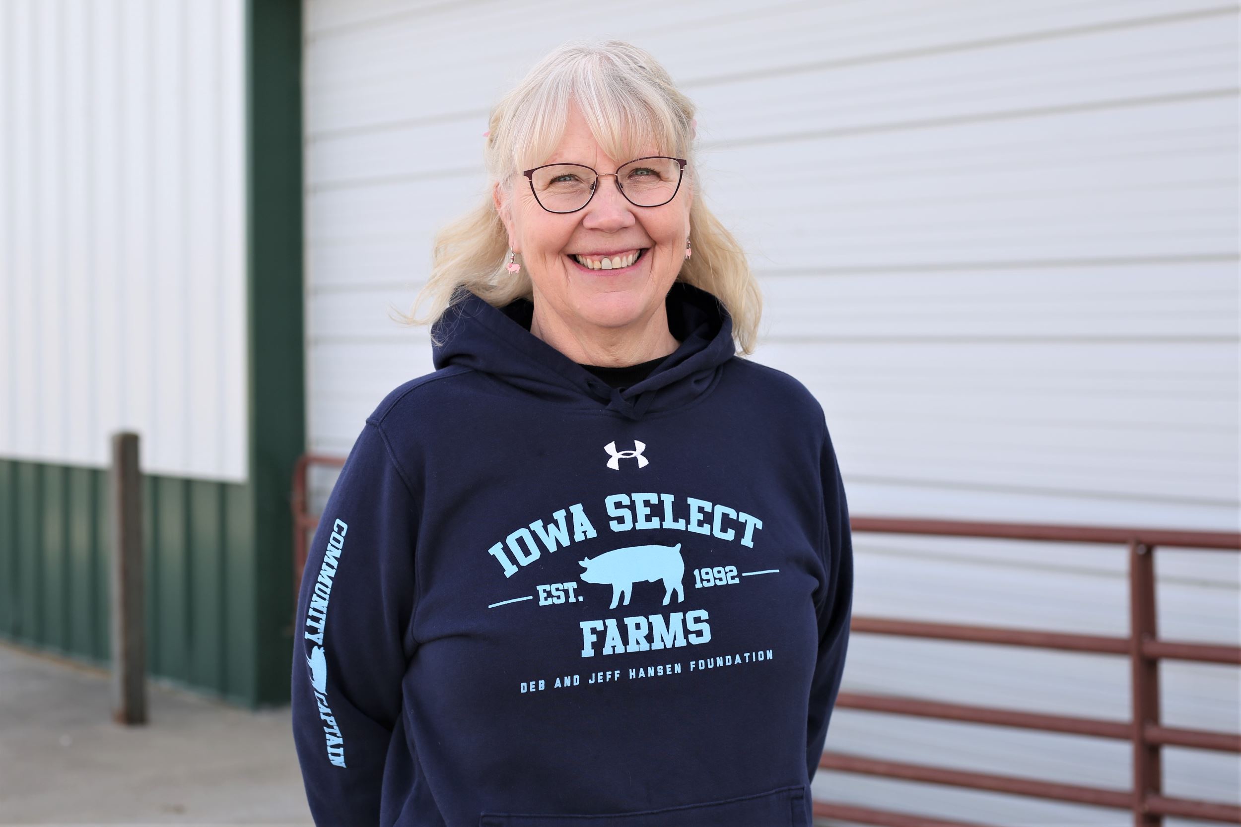 Jessica smiles for a headshot in her community care captain sweatshirt