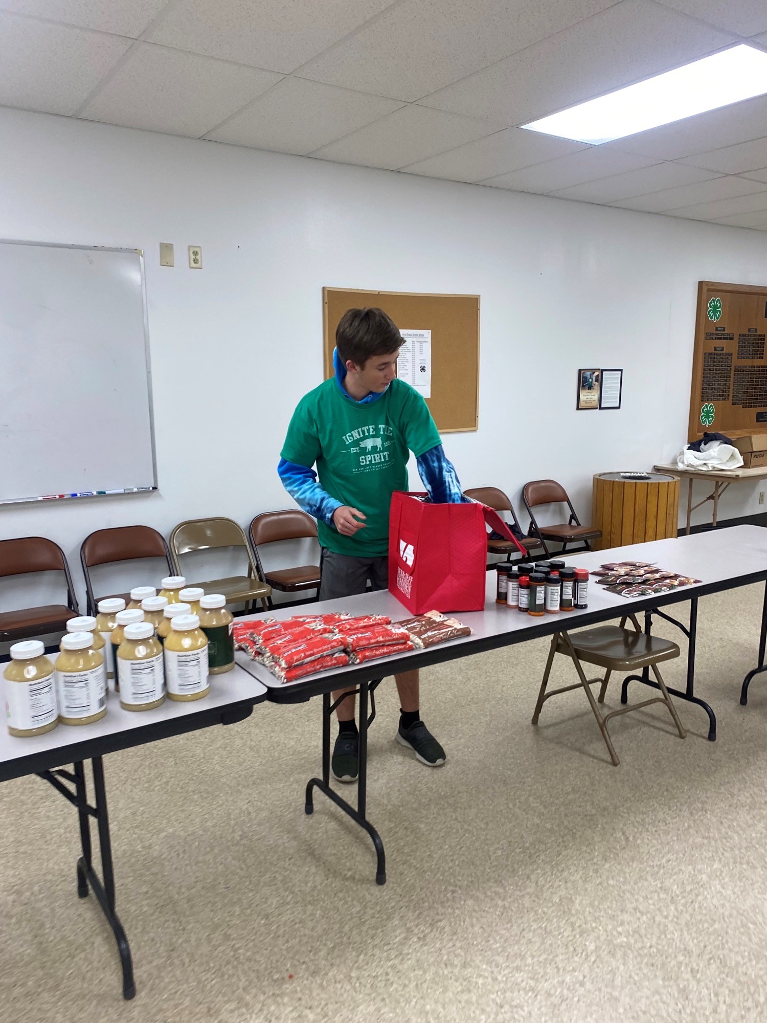 student packs a box of food