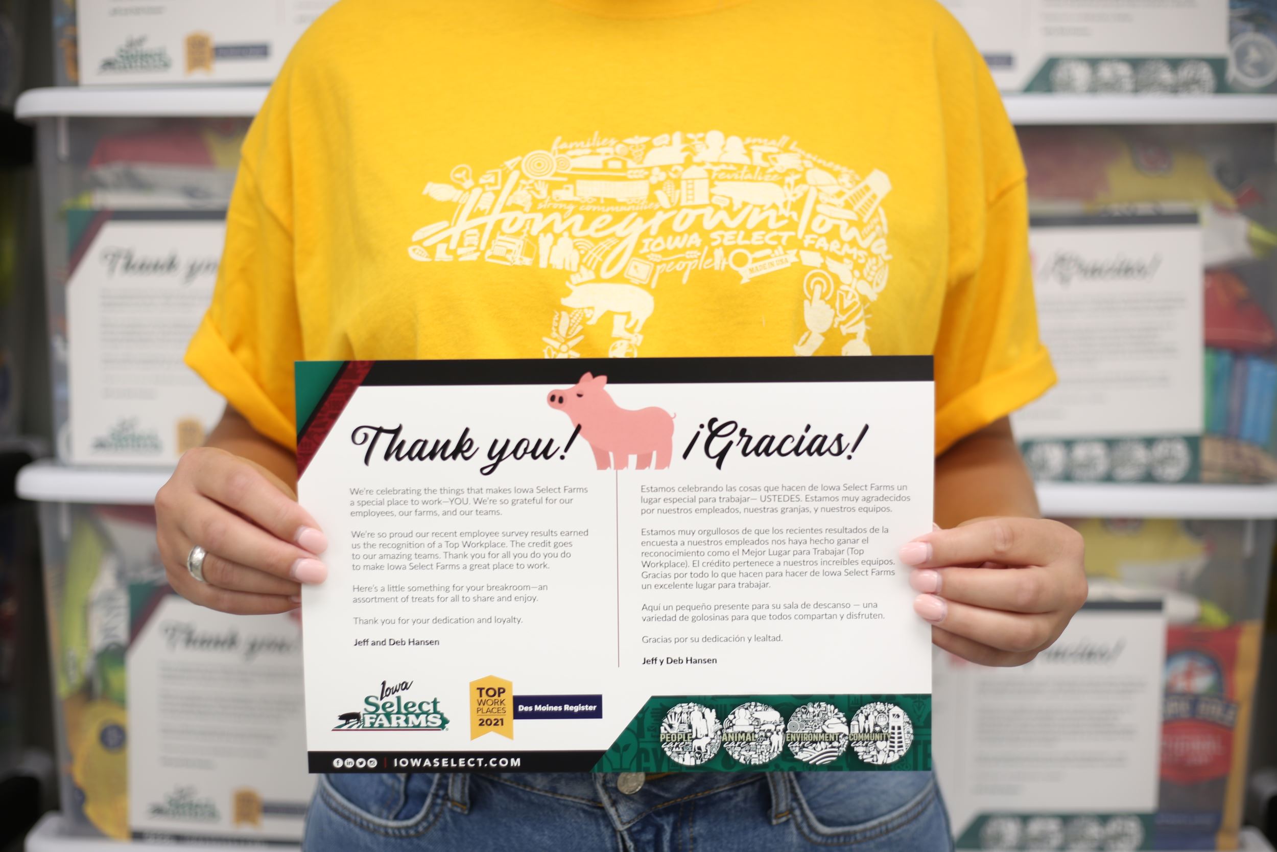 a girl in a yellow shirt holds a sign that says thank you