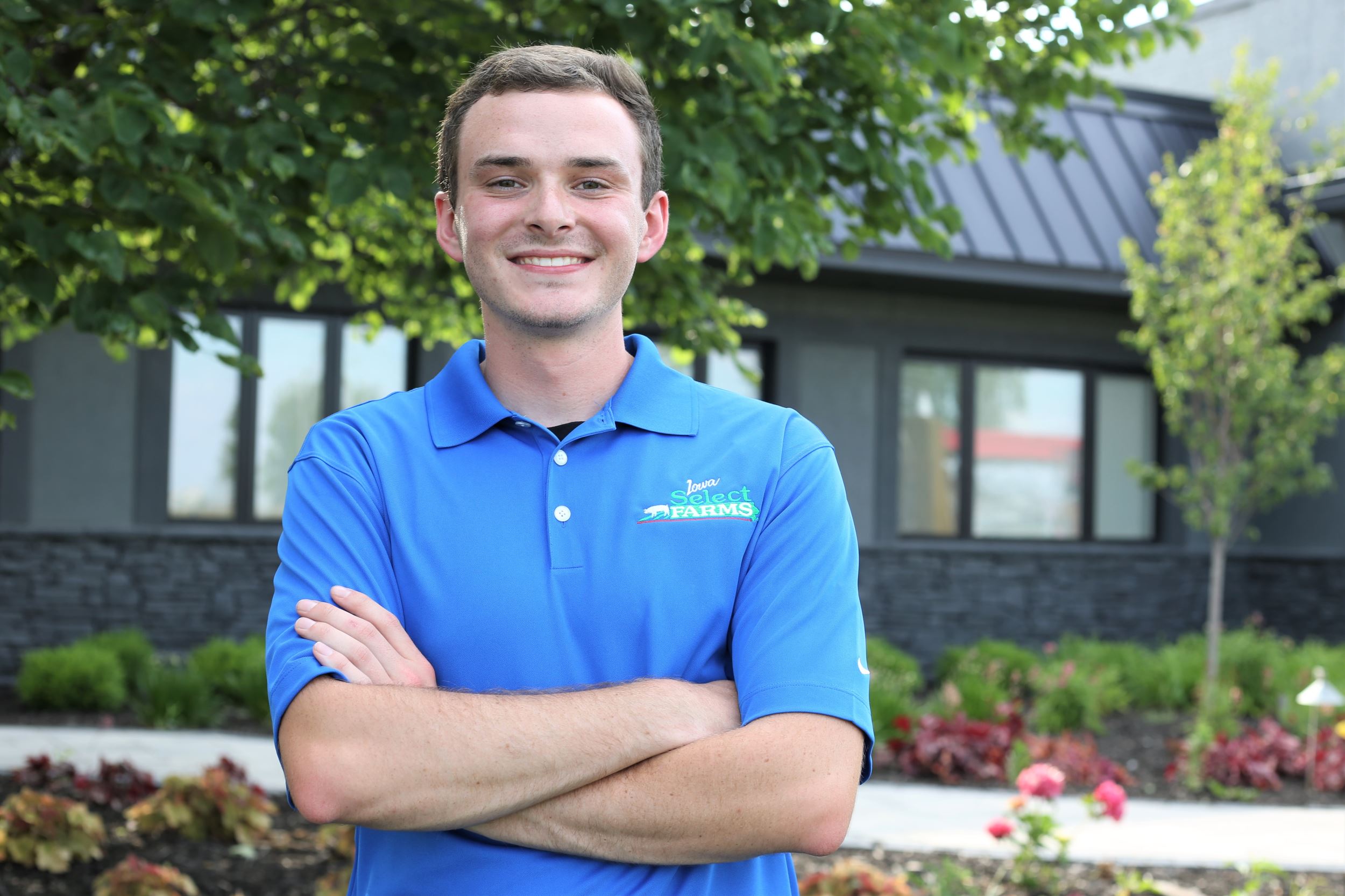 Michael poses in his blue intern polo