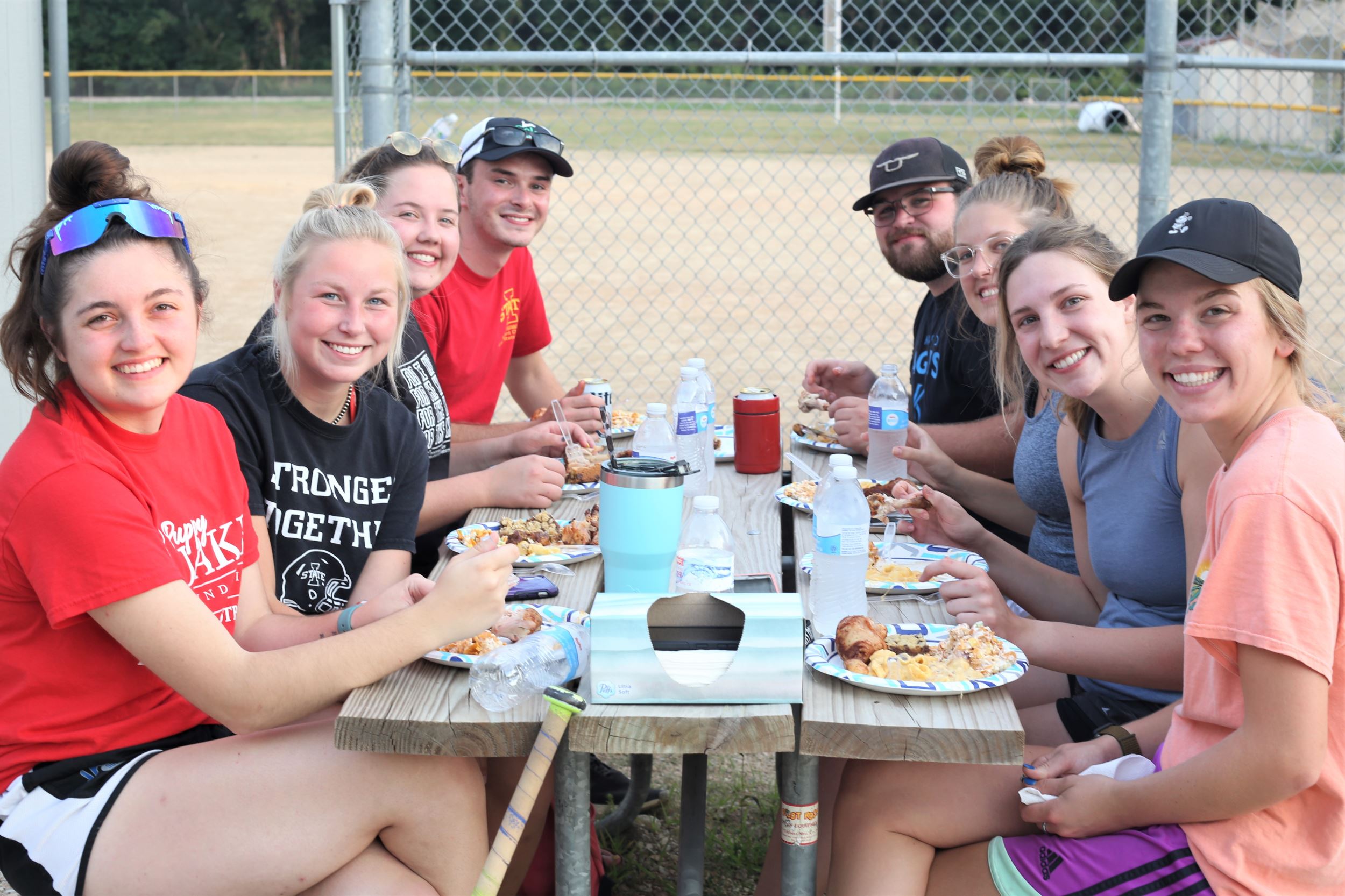 Some of the interns sit together eating dinner.