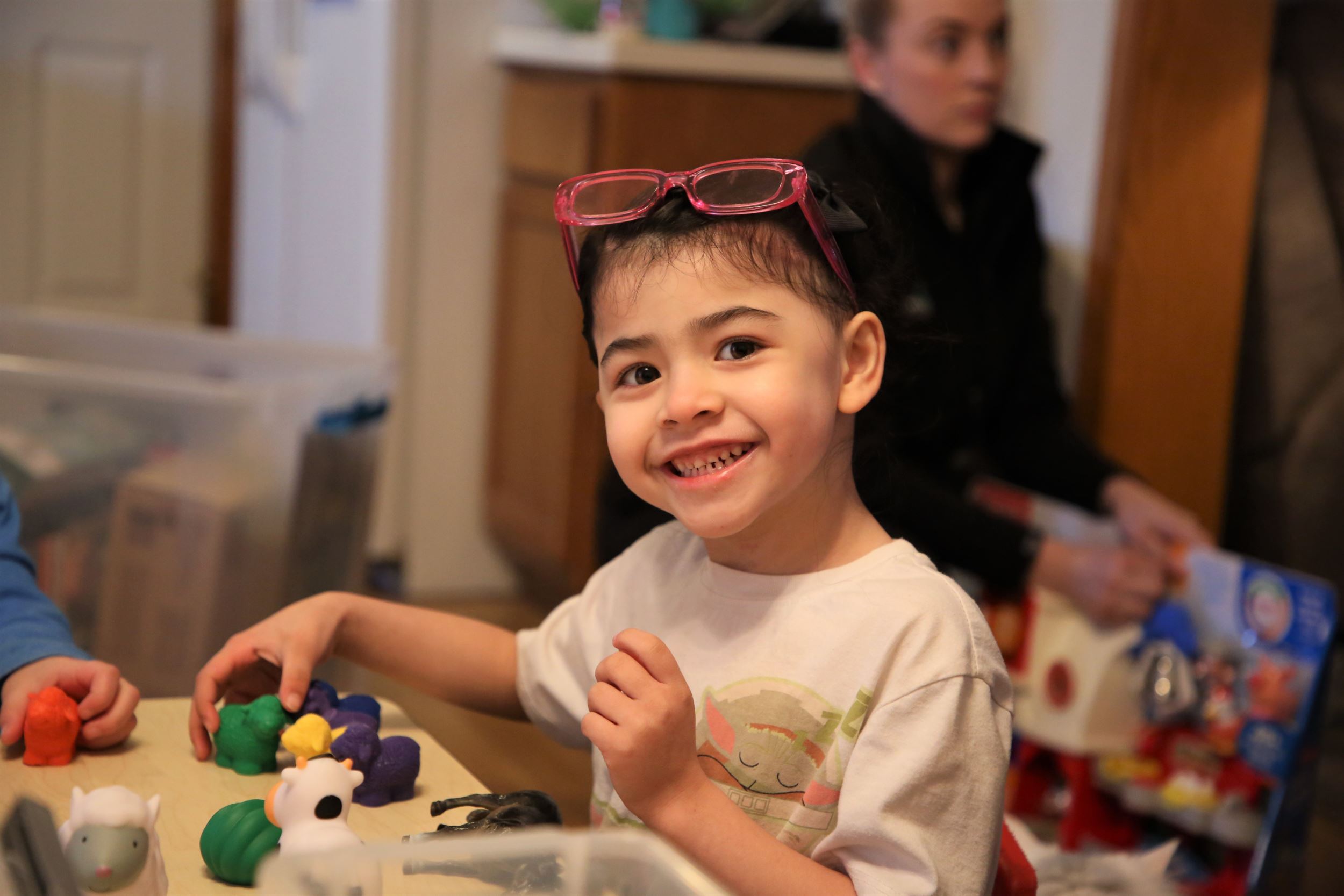 child smiles with toys