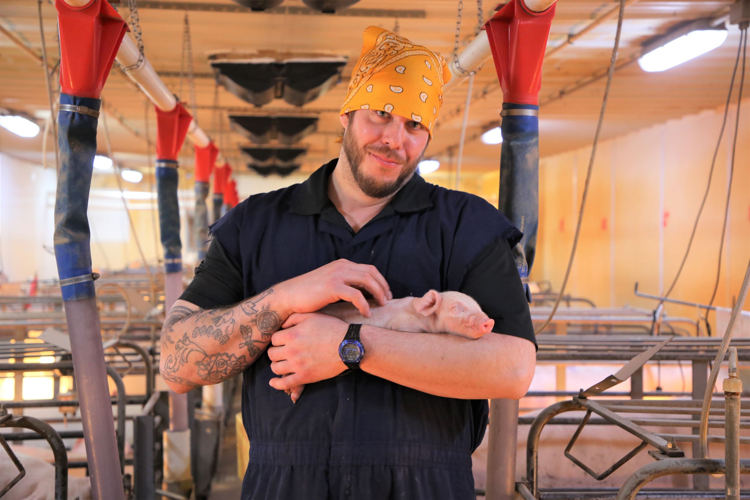 caleb holds a piglet