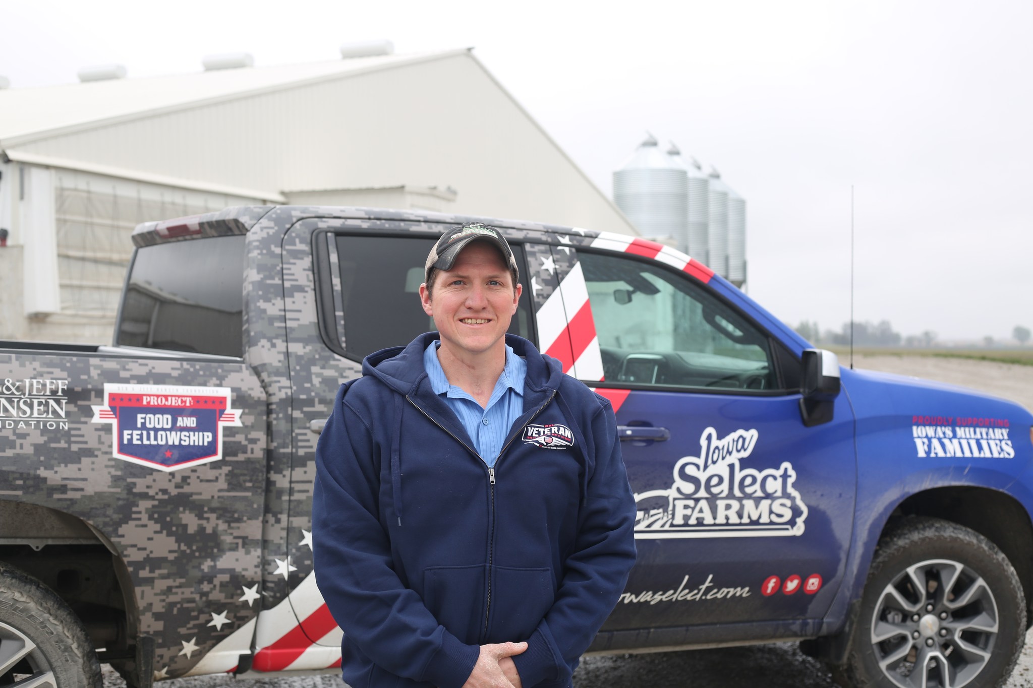 Cody standing by Military Truck