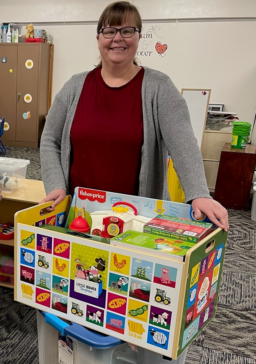 woman holds a toy box