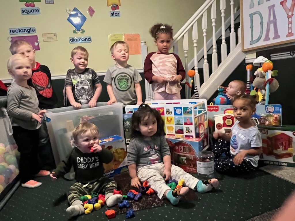 Group photo of children with toy box