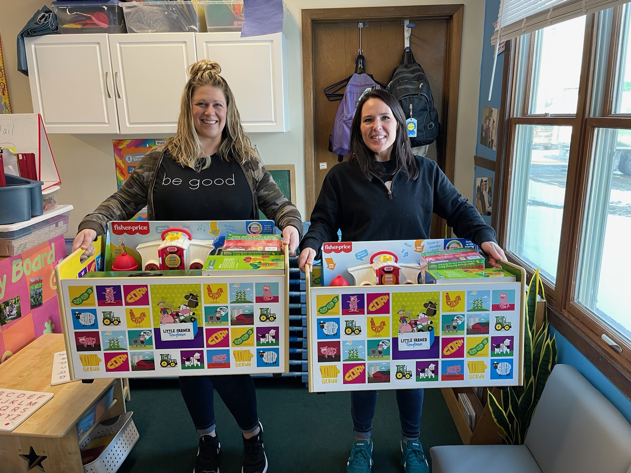 Two women hold toy boxes