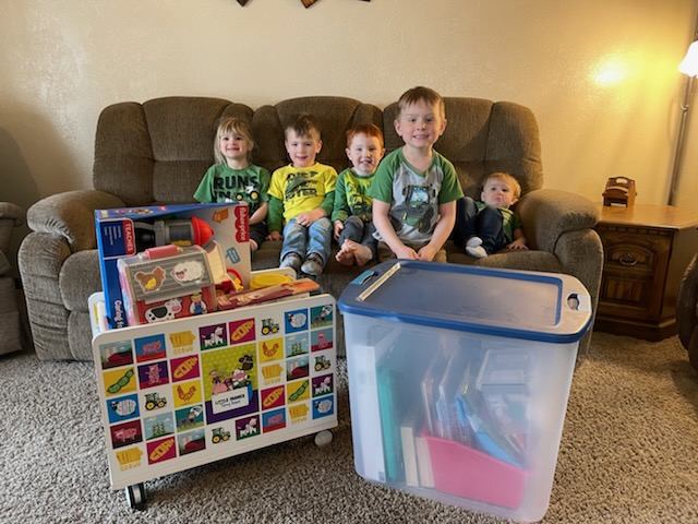 kids sit by toy box