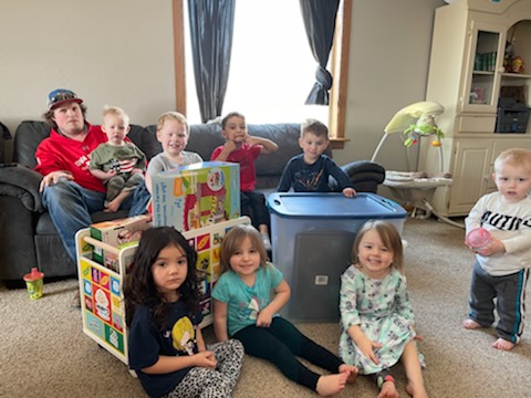 group of kids poses with toybox