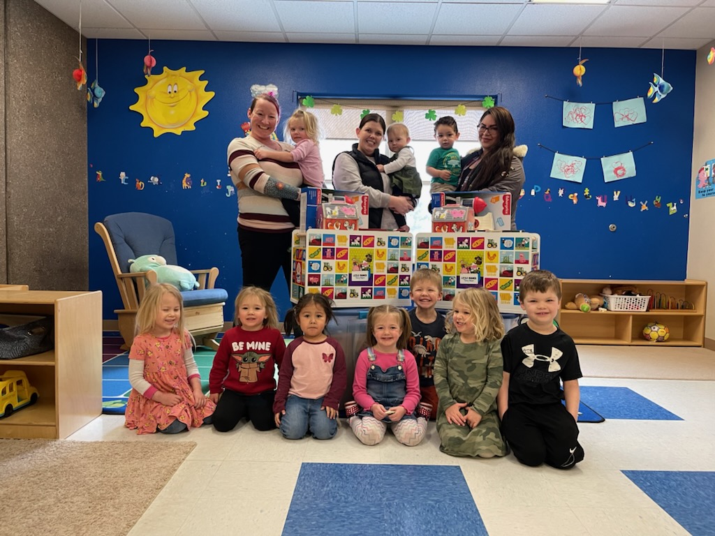 group poses by toy box