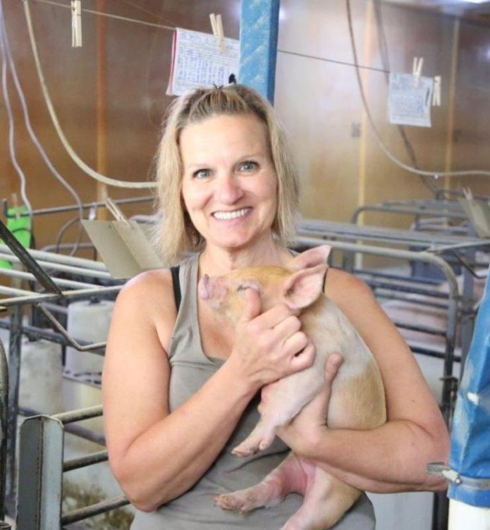 Julie holding a piglet