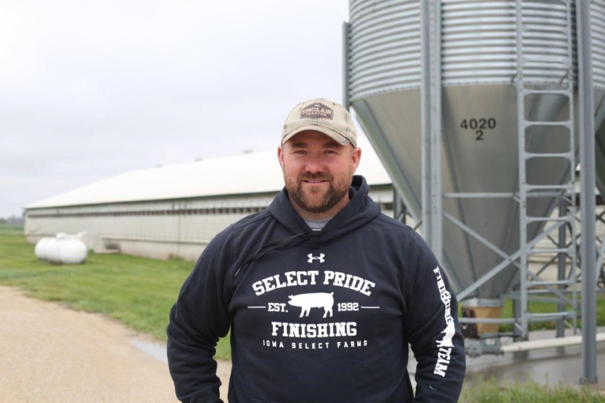 Lane outside his farm with the feeder