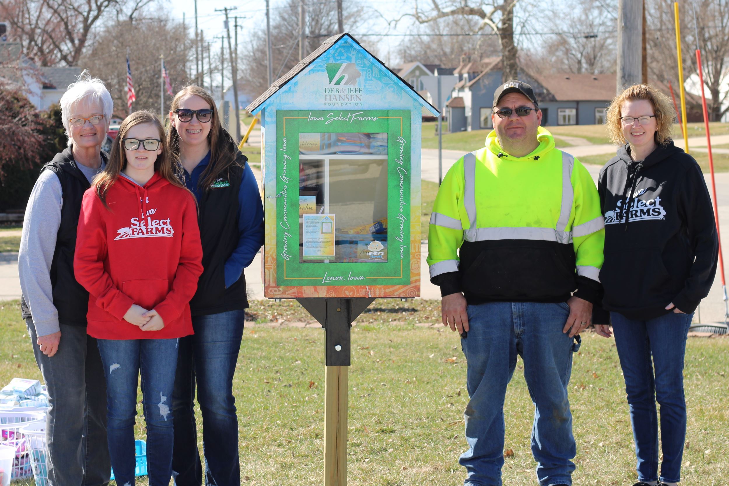 Courtney and her family pose in front of their pantry.