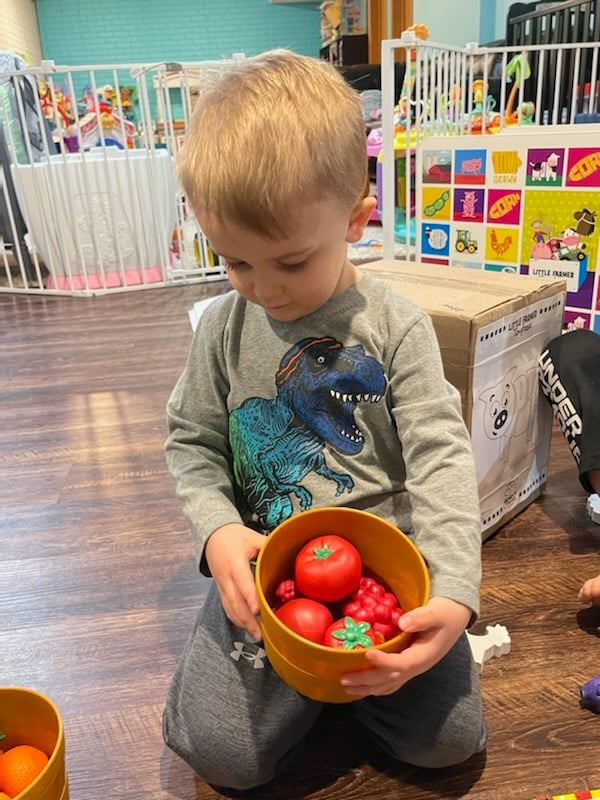 Little boy playing with red items