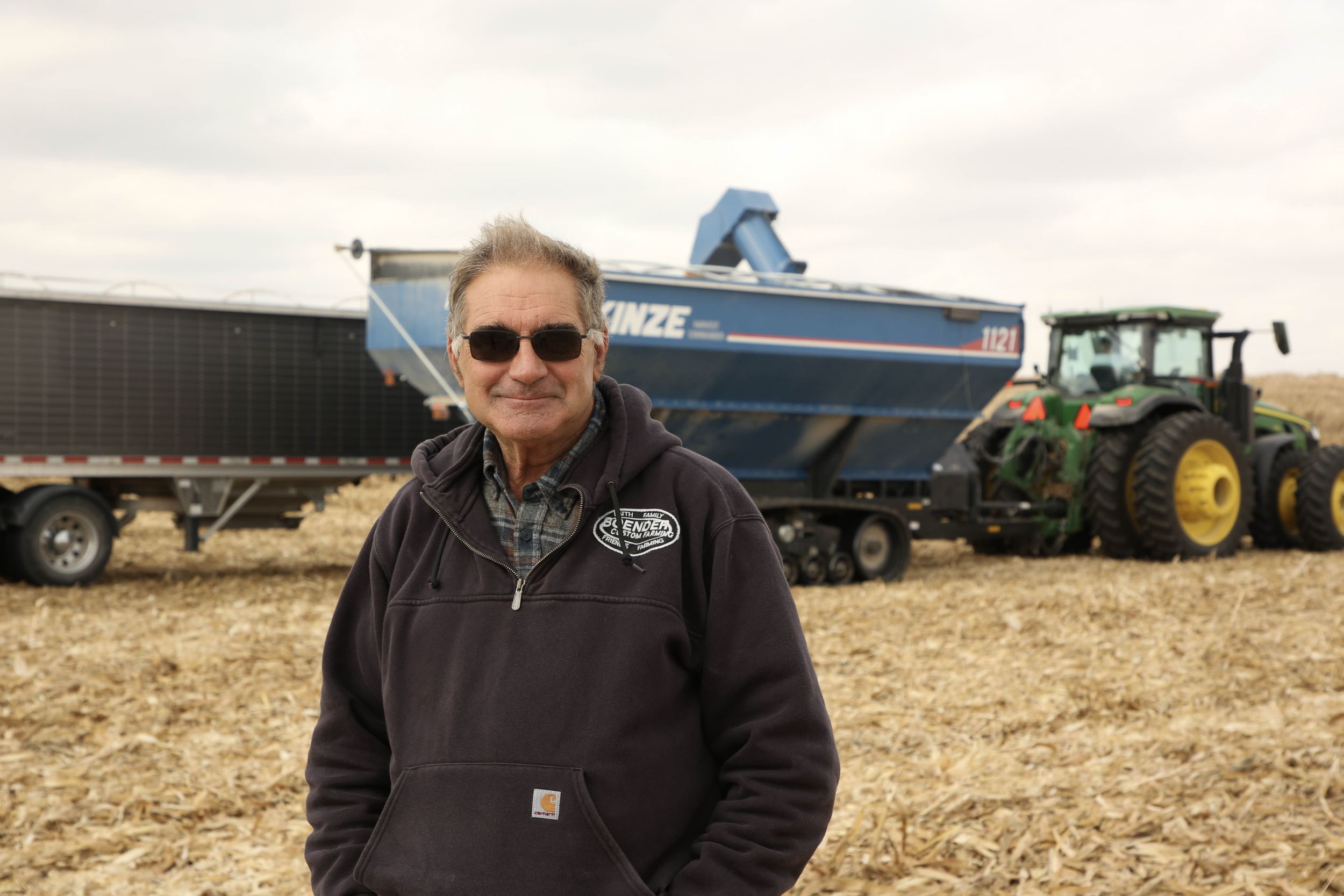 Steve with tractor in a filed at harvest.