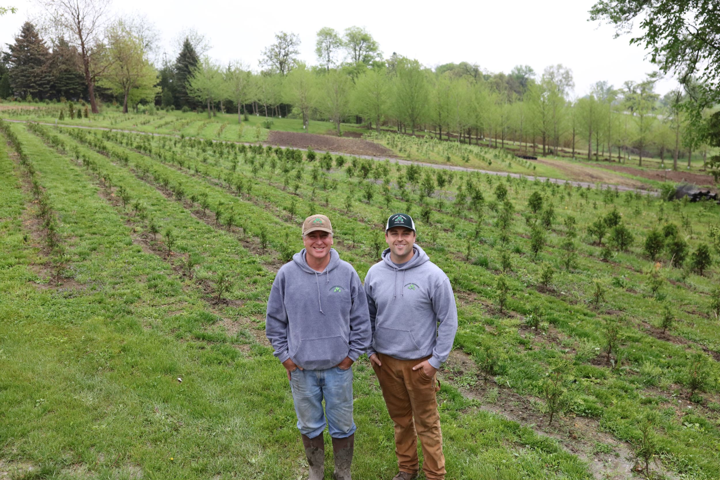 John and Alex in front of tree farm