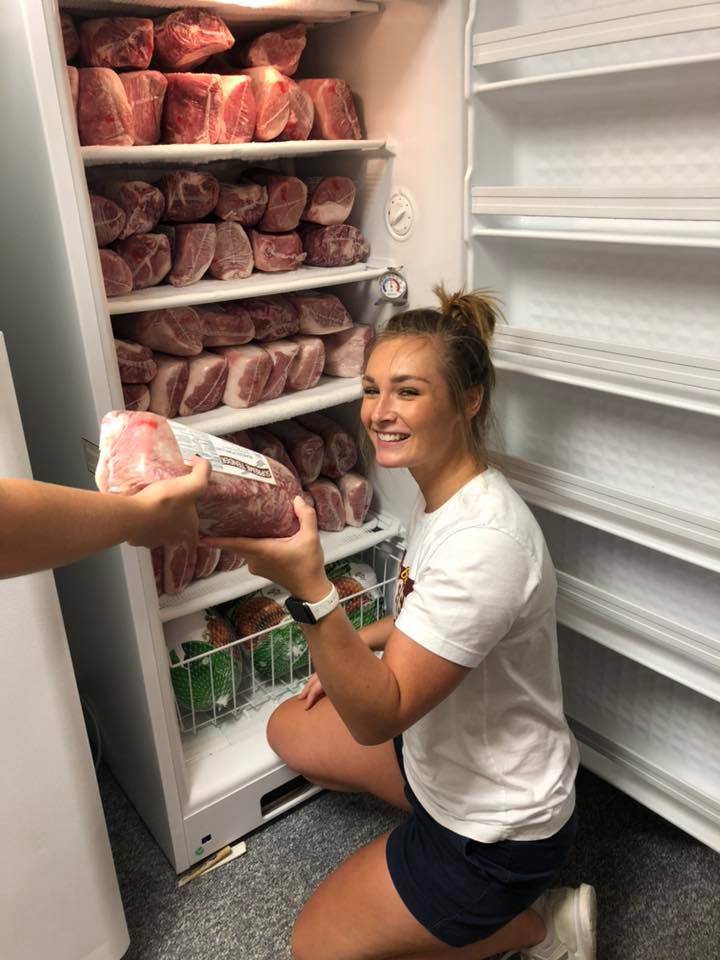 Lexie putting away pork loins