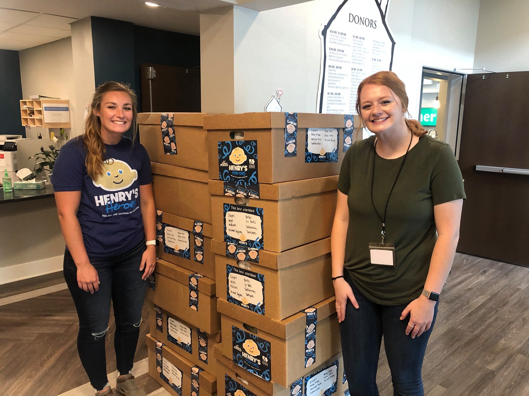 Lexie and Kaitlyn standing by donation 