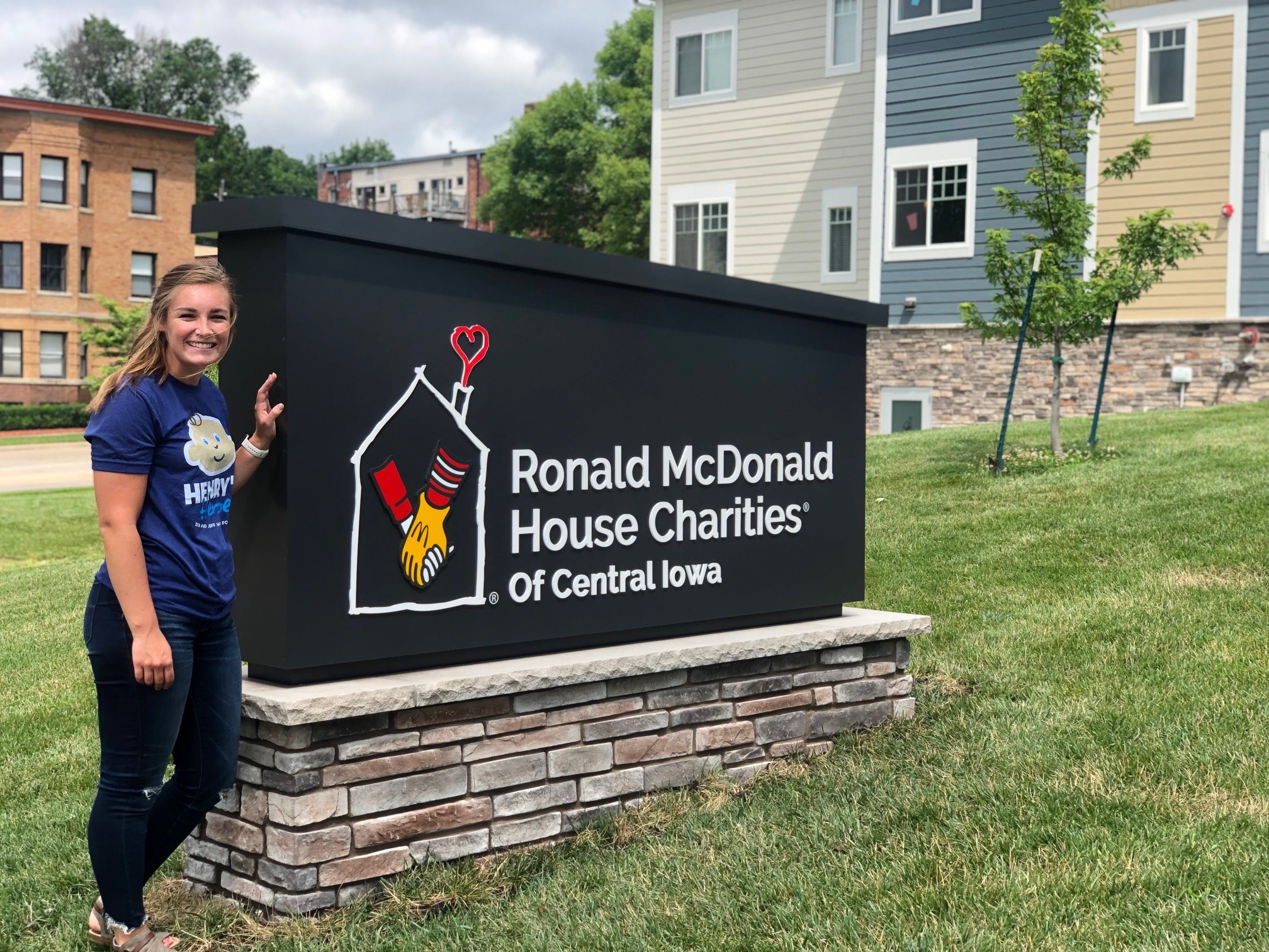 Lexie standing by Ronald McDonald sign