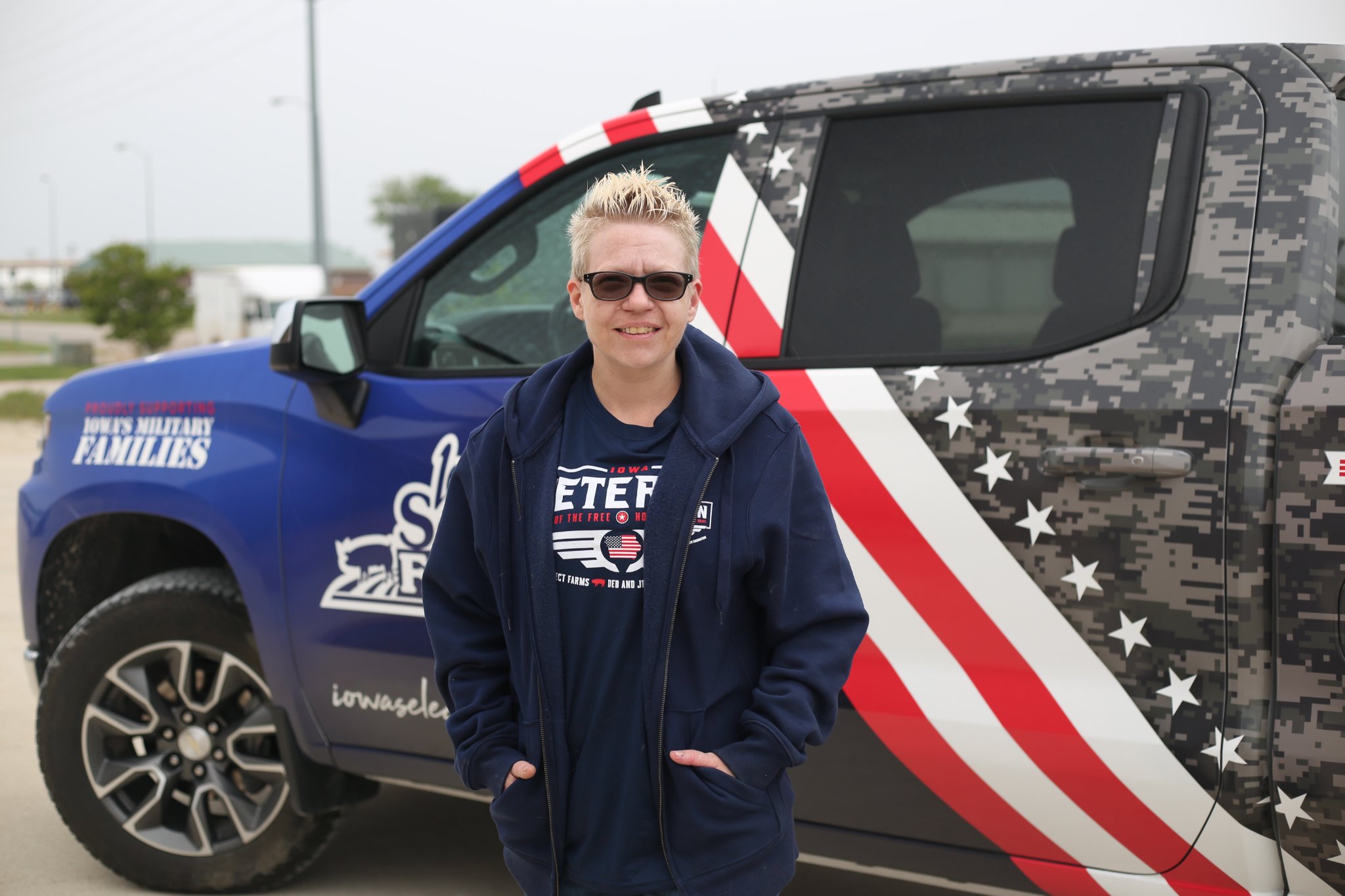 Jamie standing by military parade truck