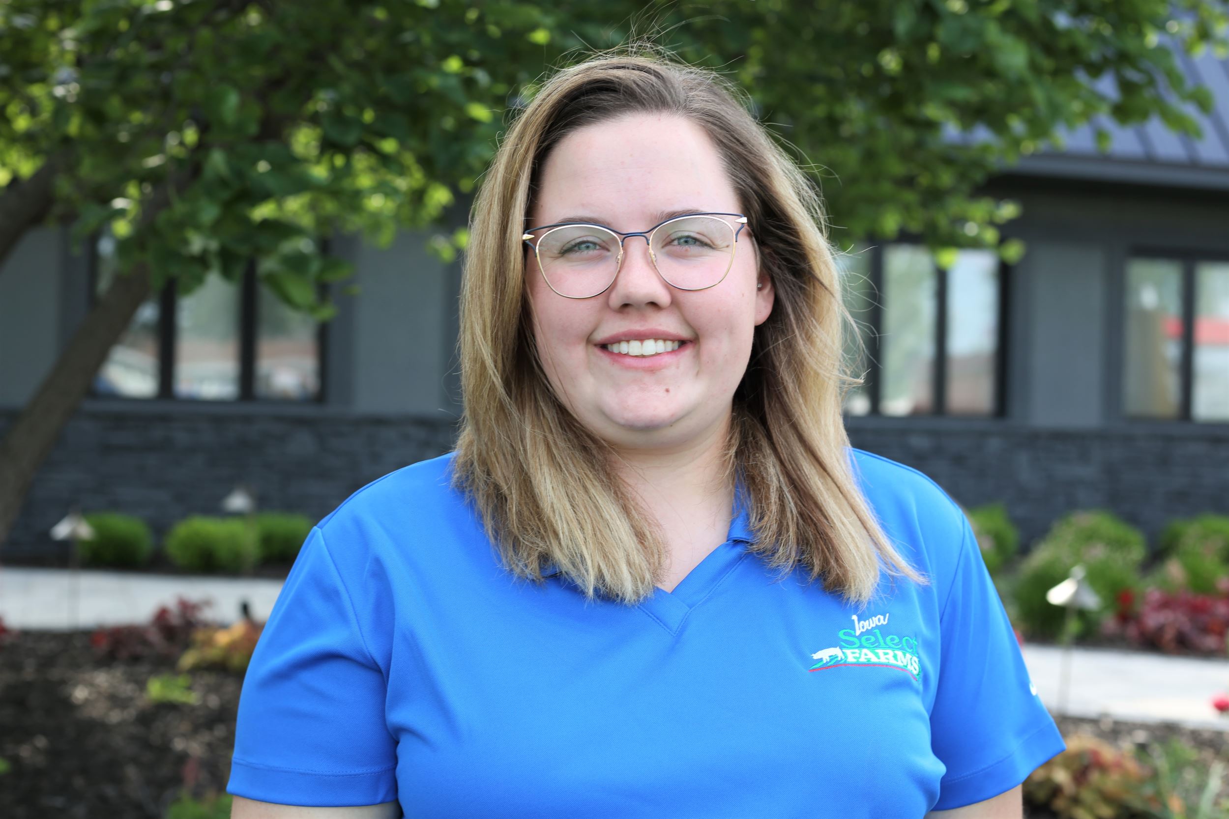 Kiley smiles for a professional headshot.