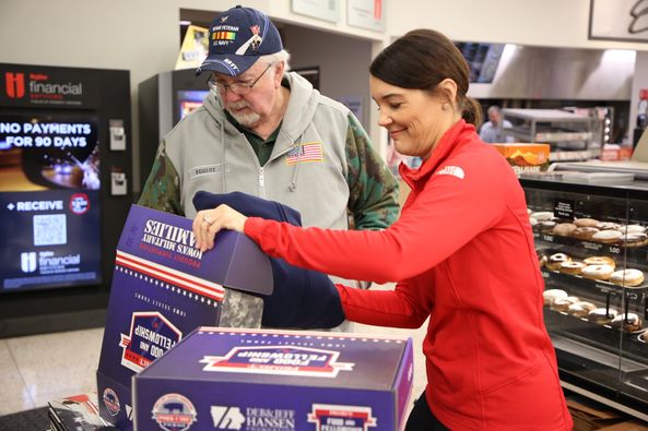 Jen handing a veteran a sweatshirt